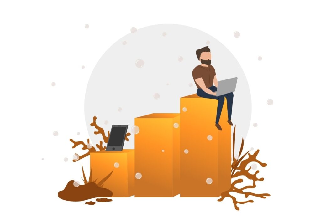 Morgan sidder med sin laptop, og har sin mobil i nærheden